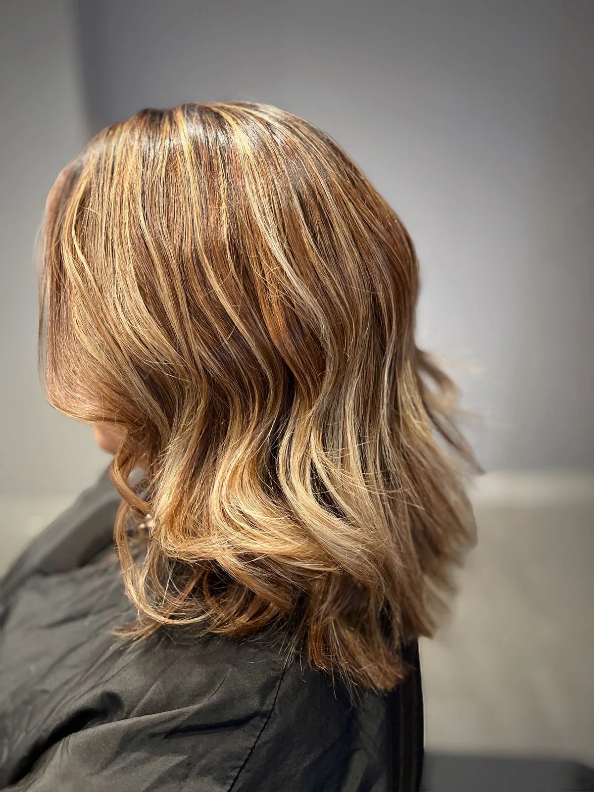 Brunette with golden balayage and beachy waves
