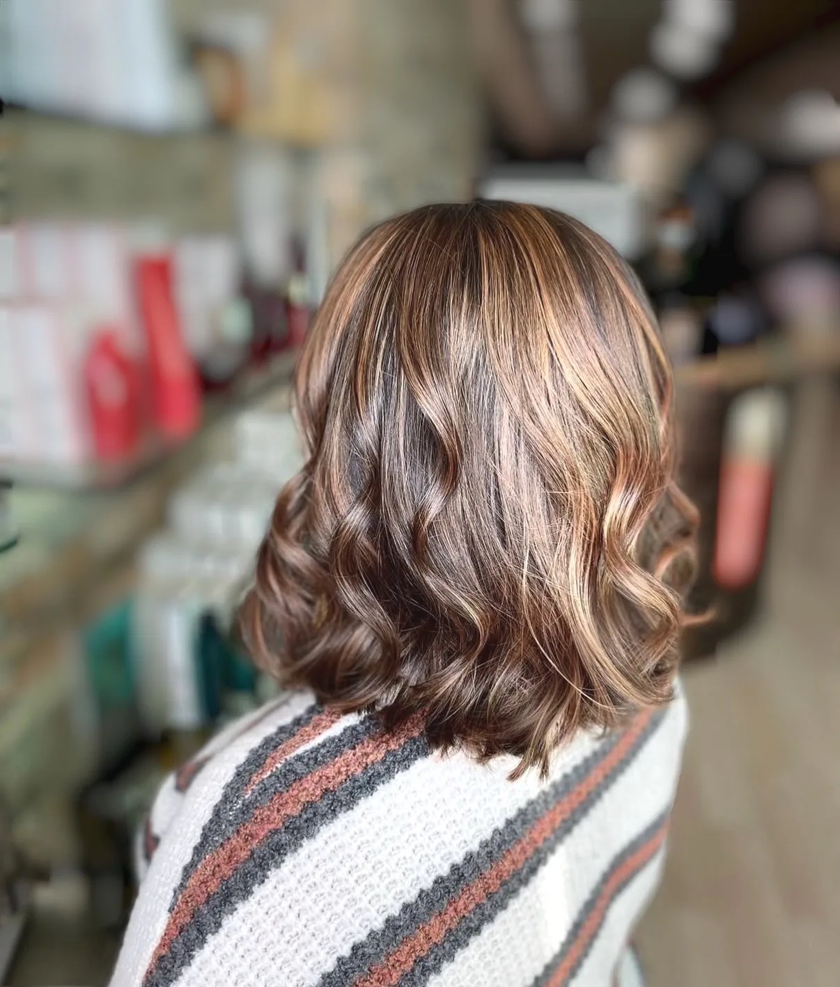 Caramel balayage with textured waves on brunette lob